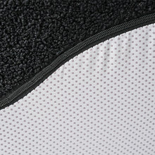 Load image into Gallery viewer, Close-up of a black textured mat corner transitioning to a white mat with a textured surface.