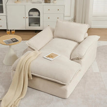 Load image into Gallery viewer, Beige armchair with a blanket and a small table in a room with white cabinets.